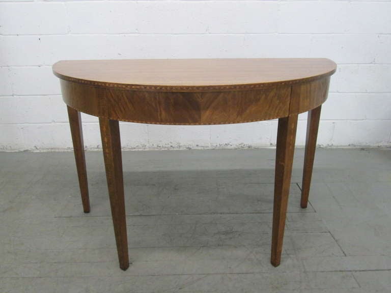 Antique mahogany demi-lune console tables.
Measures: 48W x 24D x 30H. 