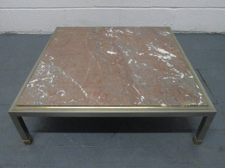 Has bronze beaded trim with bronze padded feet on a steel base.