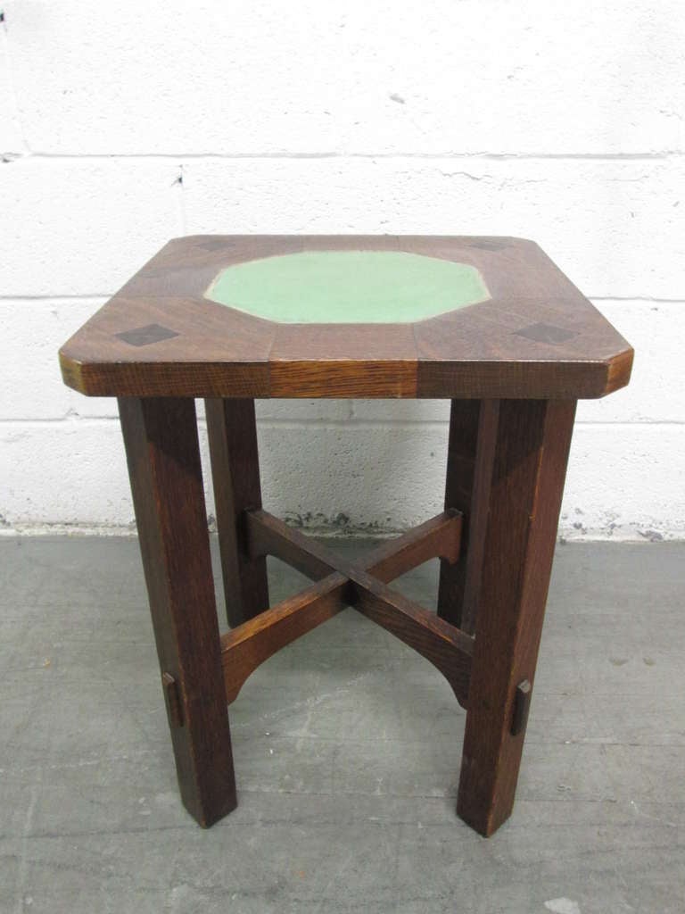 A rare Gustav Stickley and Grueby Pottery, circa 1901.
Model no. 53-T, inset with hexagonal green-glazed tile top tabouret. Would make a nice complement to a Mission or Arts and Craft interior.
There is another one similar available. Please