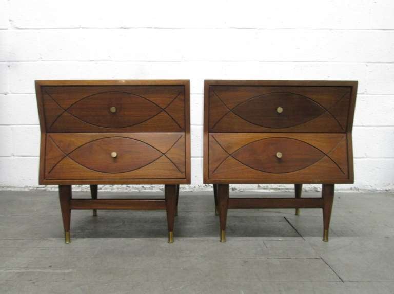 Great looking mid century modern walnut  with two pull out drawers.  Have angled sides and a decorative pattern to the front drawers and brass feet. 

Also listed and sold separately is the matching high chest.