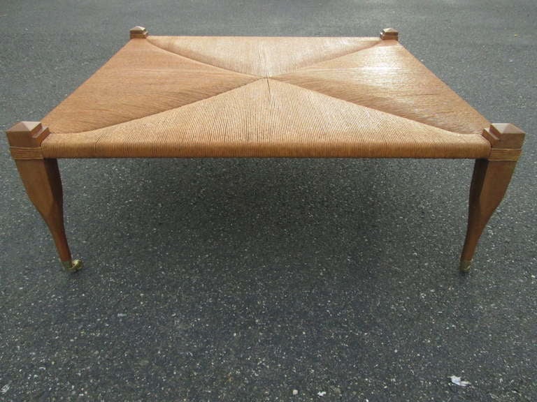 Large hand woven Rush Top Bench / Coffee Table.  Has a glass top insert.  The legs are solid mahogany with brass wheels.