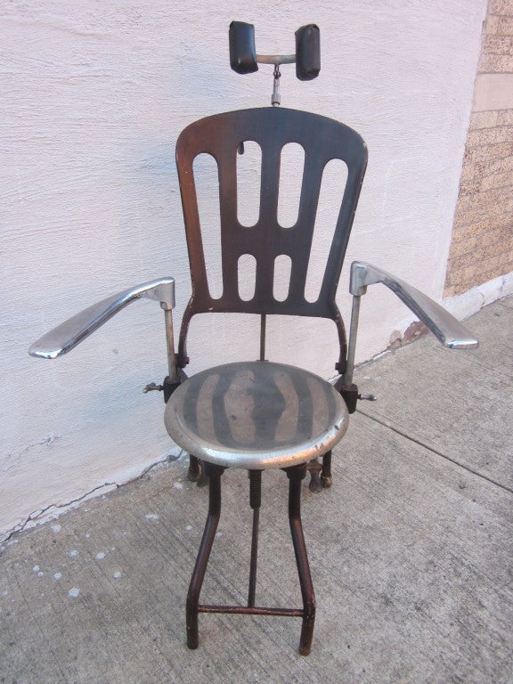 1930s adjustable dental chair.  Arms swing outward and the backrest is adjustable.  Nice item for prop purposes or for a collector.