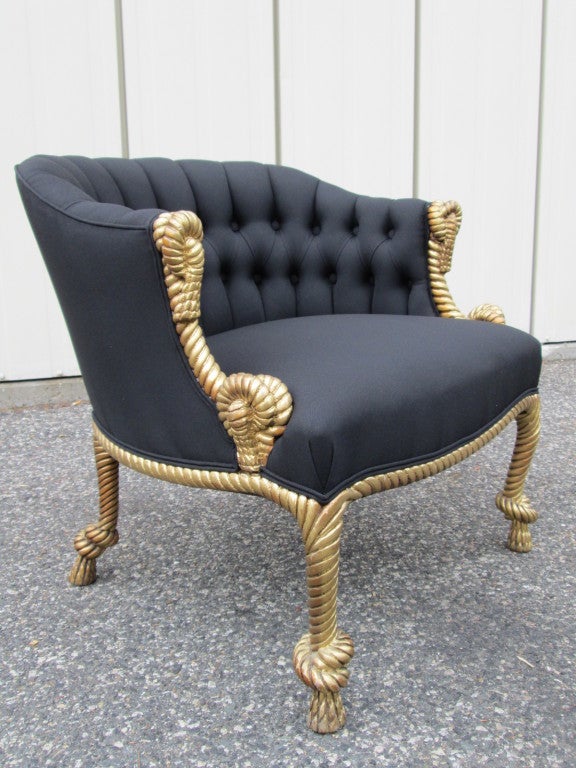 Stunning pair of black tufted chairs with rope and tasseled frame.