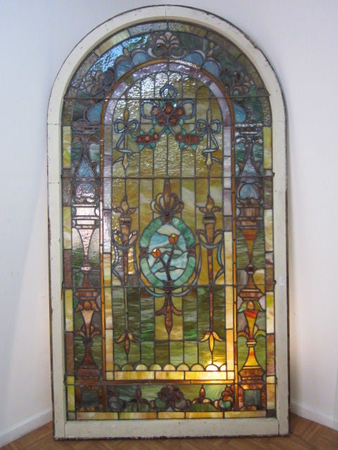 Large antique, beautiful leaded stained glass arched window with a total of six jewels.