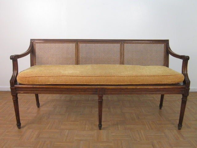 Beautiful, French, Louis XIV style, caned bench with fabric covered cushioned seat.Some losses to the cane seat