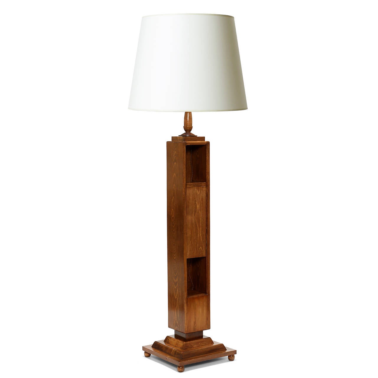 Standing lamp by DIM (Décoration Intérieure Moderne), René Joubert (1885-1931) and Philippe Petit (1900-1945), consisting of a square column upright and stepped base on four spheres, with two integrated display shelves and a concealed storage