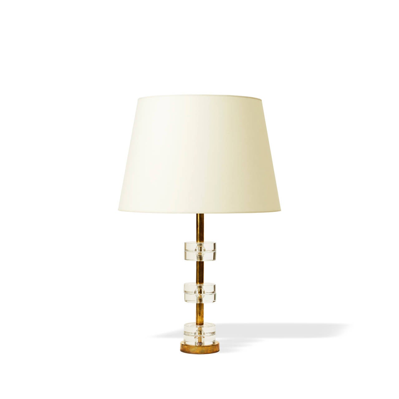 Glamorous deco-inspired lamp with brass base from which three pairs of cast glass disks are suspended at intervals, designed by Carl Fagerlund for Orrefors, Sweden, mid-20th century.