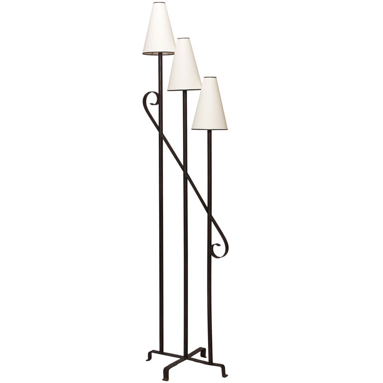 Three light standing lamp in iron by Jean Royère For Sale