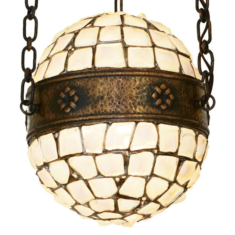 This spectacular hanging fixture in hammered bronze and chunky pieces of art glass is most likely a one-of-a-kind item designed by an architect for a particular interior. Mount: 13” diameter; Globe: 10” in diameter, 13” high. Currently 26” high,