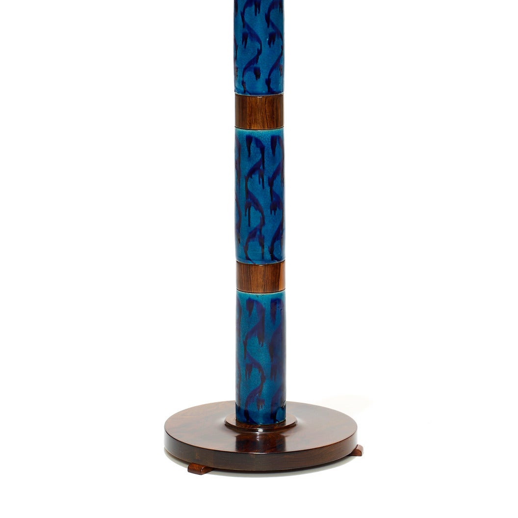 Rare model standing lamp with hand-painted foliate pattern blue-on-blue tiles (wonderful dreamy exotic character) alternating with sections of rosewood, with round rosewood base on three feet, designed by Stig Lindberg (1916-1982) for Gustavsberg.