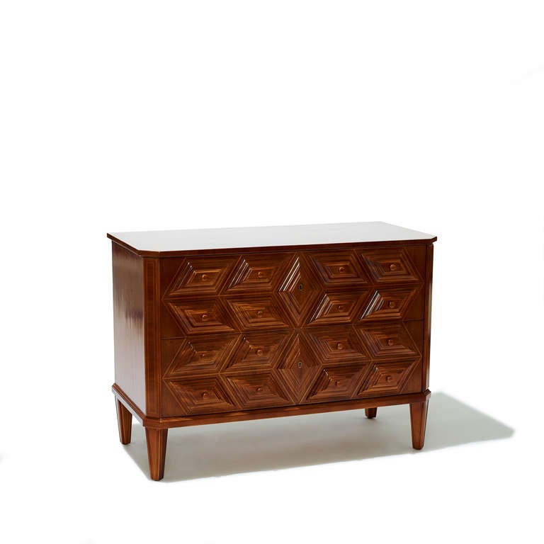 Oscar Nilsson-designed Northern Baroque style chest of drawers, with chamfered corners, tiered lozenge panels, and contrast outline inlays. Executed in mahogany with light hardwood inlay, Sweden 1940s.
