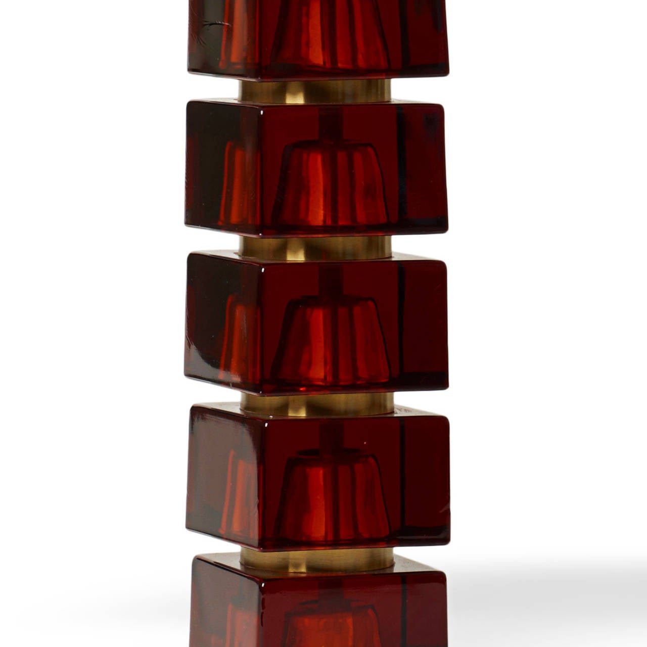 Pair of table lamps by Carl Fagerlund for Orrefors, with bases consisting of stacked squared whiskey-hued glass blocks with round brass separators, cast glass with brass. As per the high production standards at Orrefors, each block is pigmented