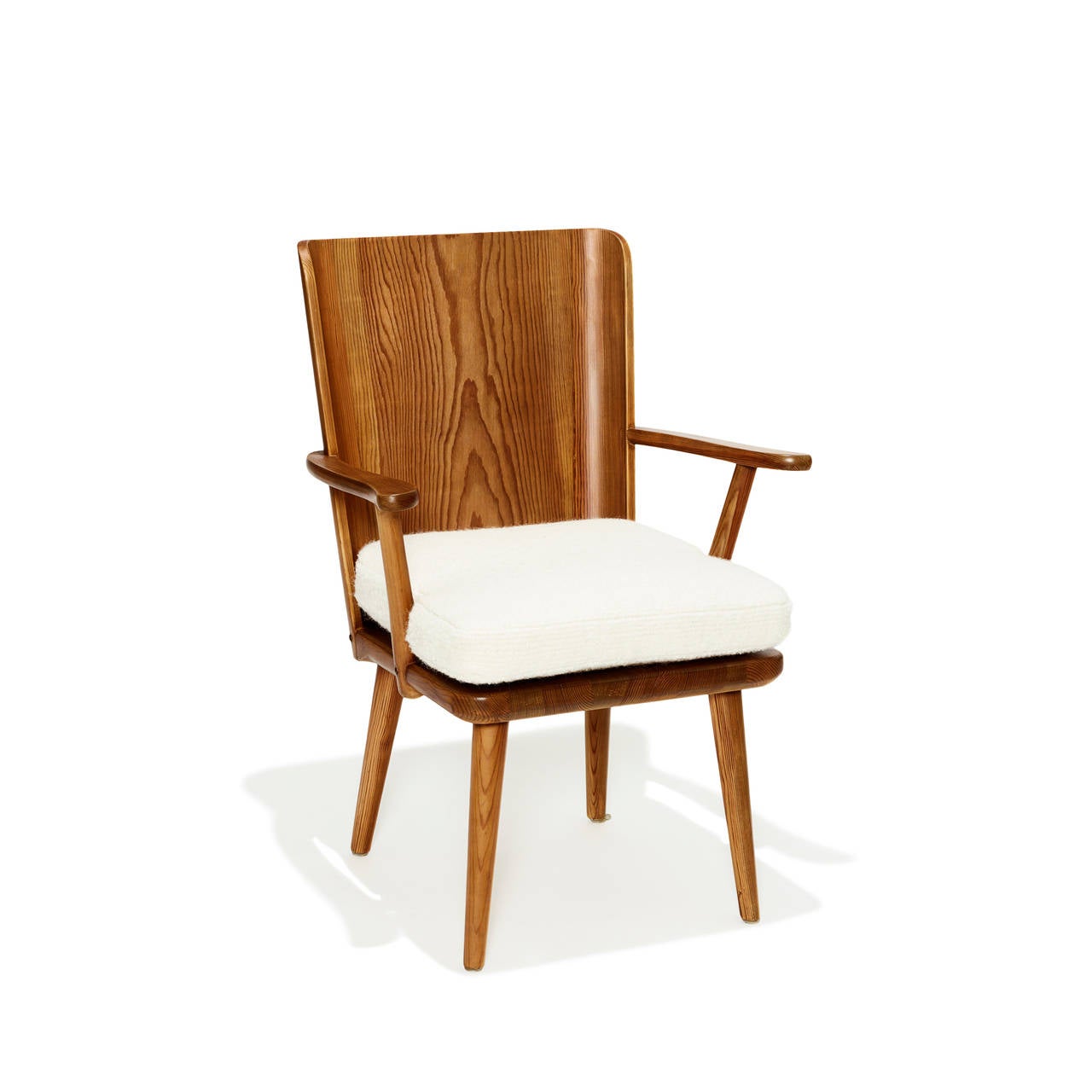 This pair of armchairs in solid pine with bent laminated pine back is a wonderful example of Swedish modernism's ability to use aspects of traditional furniture forms to soften modern design for the home. Executed by Karl Andersson & Söner,