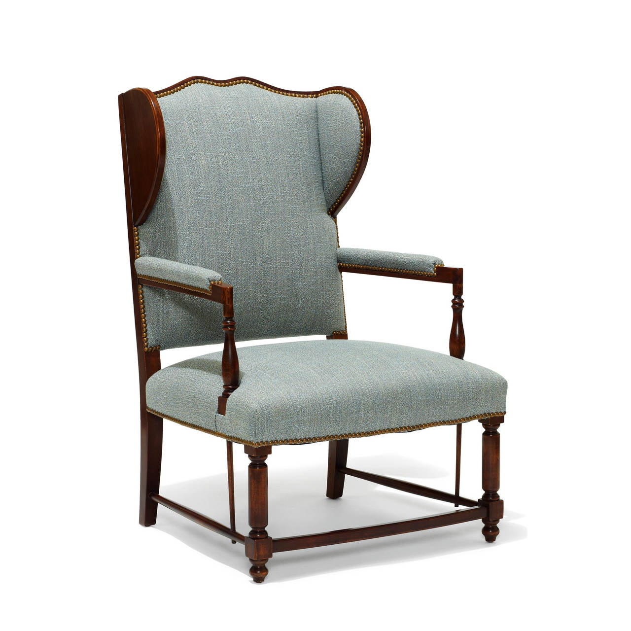 Handsome pair of 1920s Swedish wing-backed armchairs inspired by a local vernacular form, edited by an architect or designer to suit a 20th century interior. The frame, legs, and stretchers are in birch, and the upholstery is a blue/ivory silk/linen