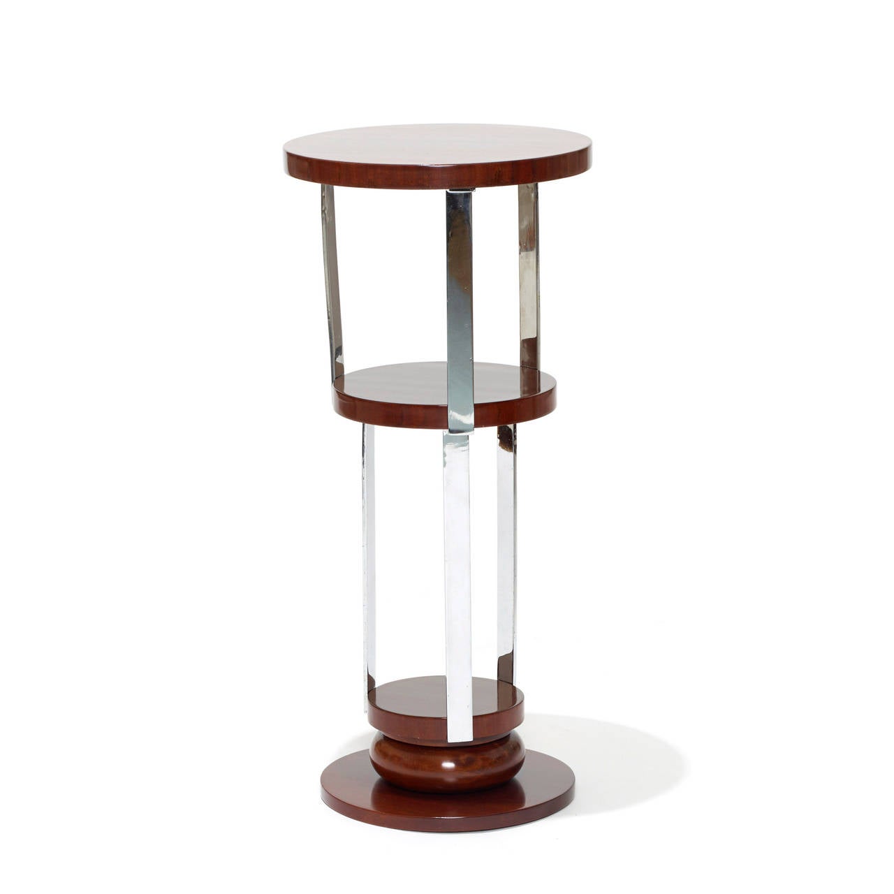 Round guéridon or pedestal by Jacques Adnet (1901-1984) with central shelf and sculptural base in rosewood and chromed metal, France, 1920s.