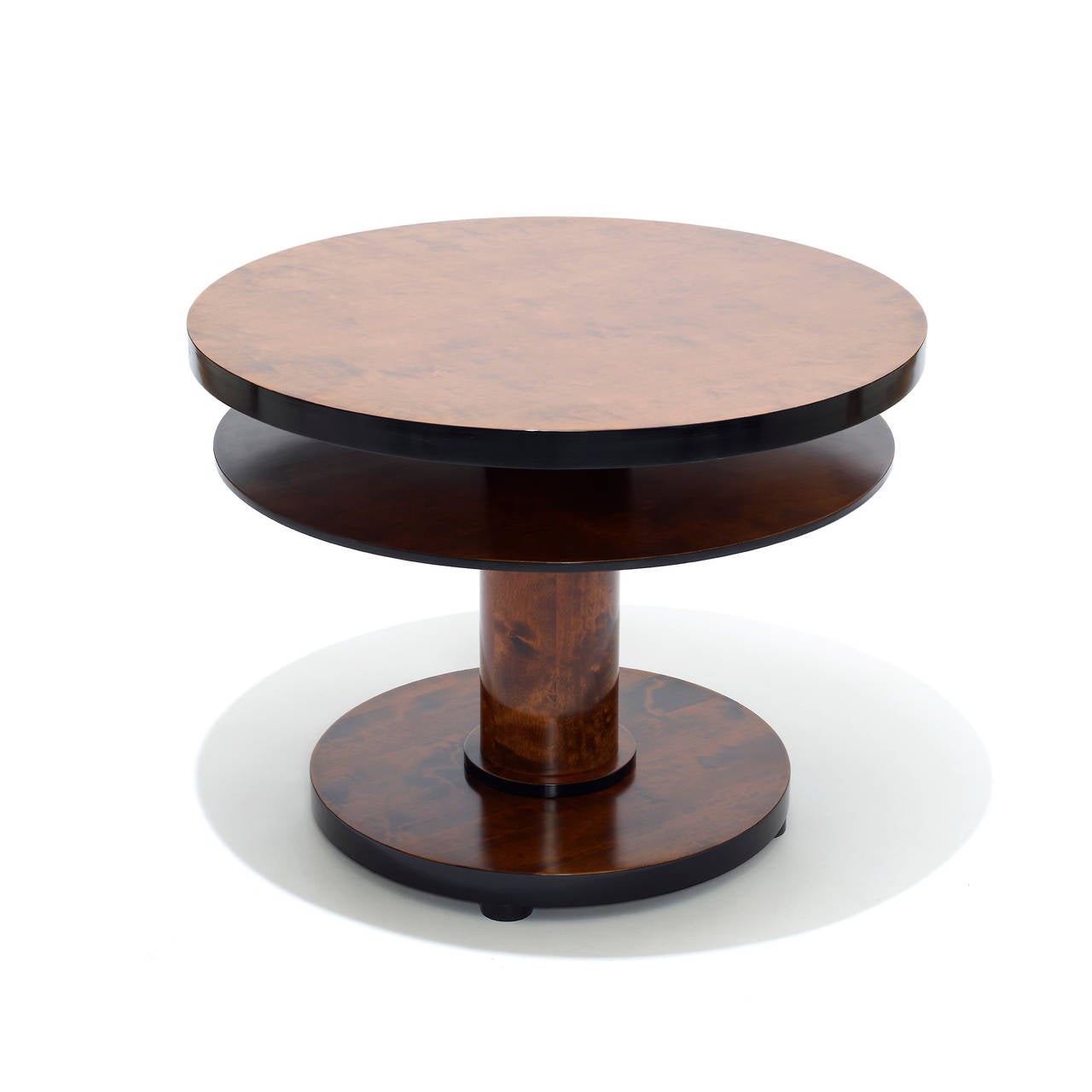 Functionalist side or occasional table featuring round shelf centered under round top, for magazines and such, in Baltic birch stained in two shades, Sweden, circa 1930.