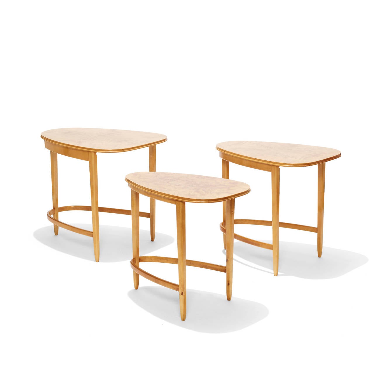 Set of three nesting tables having a wonderfully dynamic sensibility, with parabolic arch-shaped top and similarly formed stretchers, with flame birch bookmatched veneer top, birch bentwood frame, Sweden, mid-20th century.

Measures: 20.75 in. (52