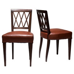 Pair of side chairs with diamond lattice in oak by Jacques Adnet