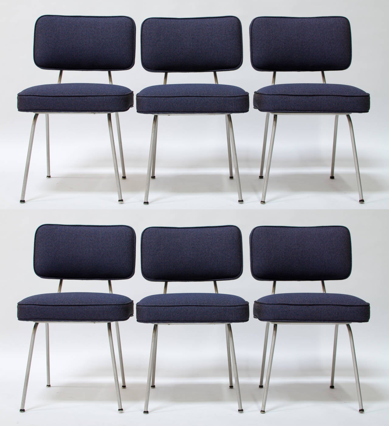 A rather uncommon and early set of six dining chair by George Nelson for Herman Miller, circa 1948, having tubular zinc-plated frames with floating upholstered seats and backs. Newly reupholstered in new old stock Alexander Girard hopsack fabric.