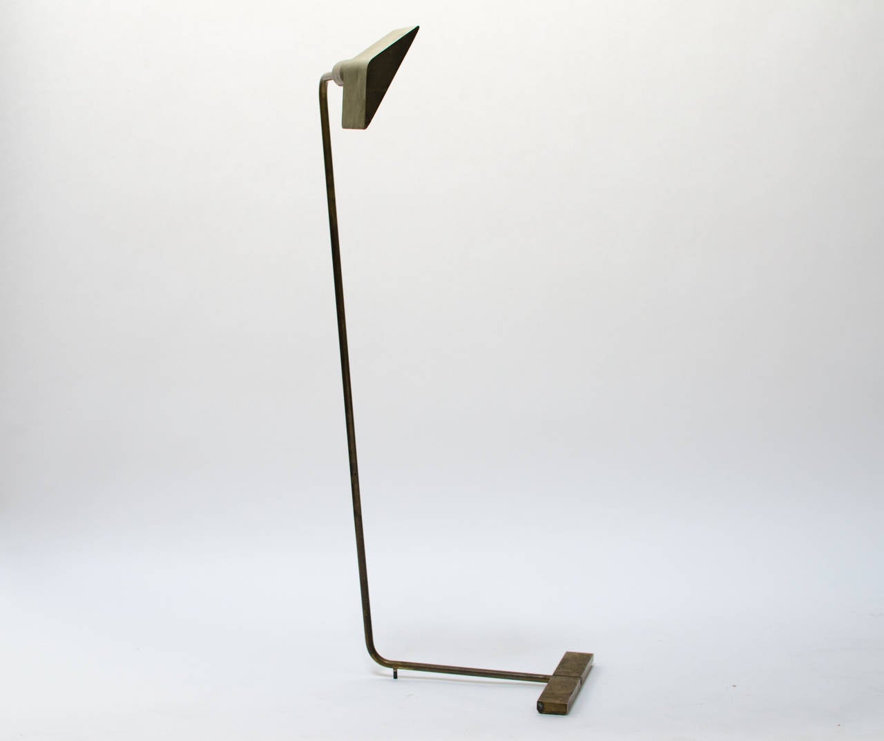 Early Cedric Hartman brass floor lamp model # 1UWV comprising of a swiveling pyramid shade with dimmer switch that cantilevers on a rotating stem with a weighted base. American, c. 1960s. Offered as found with original patina, can be polished to a