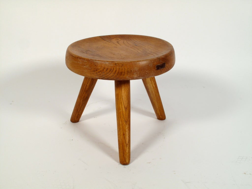 Rare low tripod stool designed by Charlotte Perriand for Galerie Steph Simon executed in oak. This is an early version. Great patina.