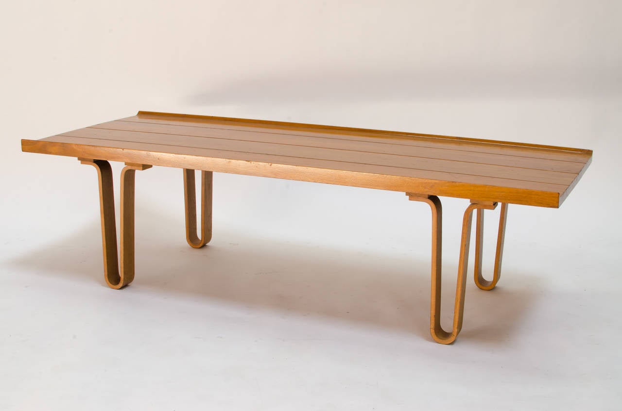 Stunning bench designed by Edward Wormley for Dunbar. Made of walnut with laminated bentwood legs.