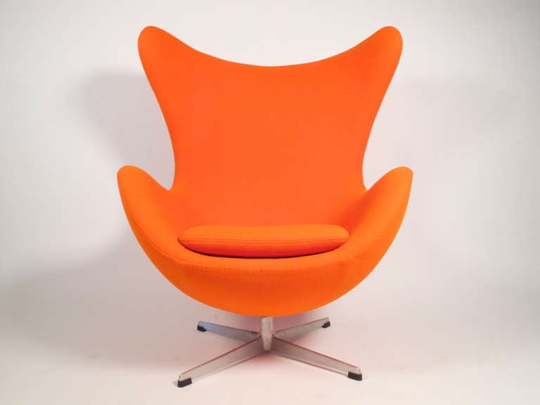 Stunning iconic egg chair designed by Arne Jacobson for Fritz Hansen. This is an early fiberglass version purchased in Denmark in 1958. Professionally recovered in orange maharam wool fabric. Signed with manufactures label.