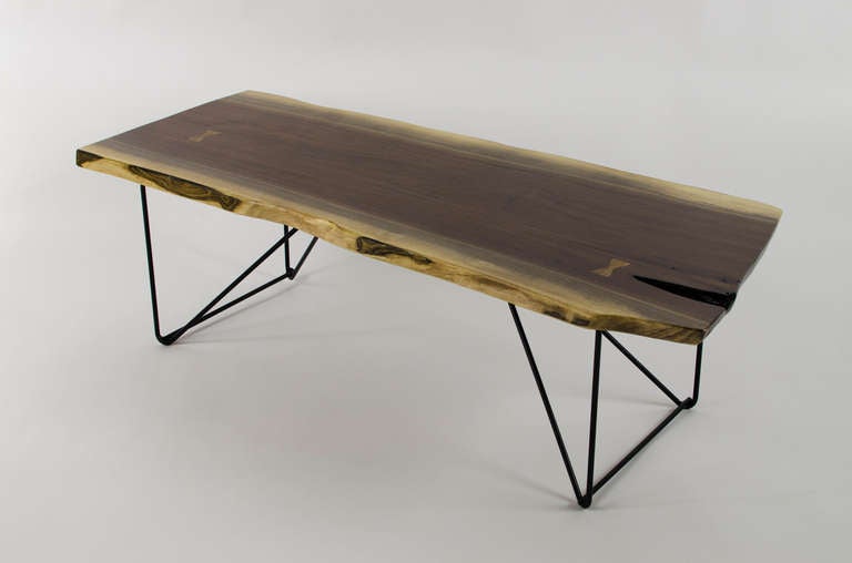 Stunning black walnut, live edge coffee table with rod iron base. Solid walnut with zebra wood butterfly joints.