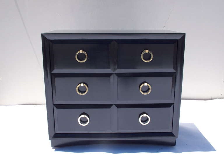 Stunning three-drawer dresser by Robsjohn-Gibbings in black lacquer. Amazing solid wood construction with dove-tailed drawers and thick solid brass pulls, circa 1952. This is part of a full matching bedroom set also listed. Bottom front has