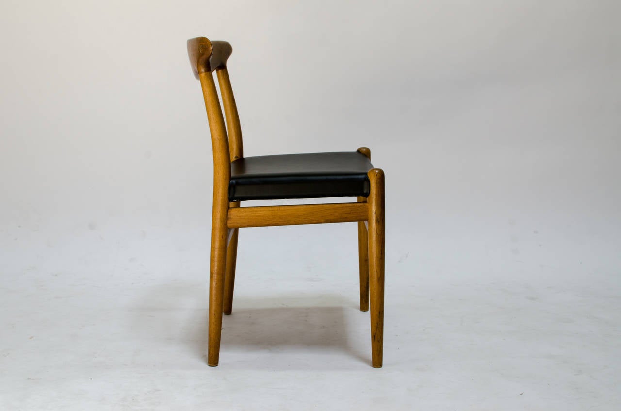 Made of solid oak, this chair was designed by Hans J. Wegner in 1953 as Model #W2 for C.M. Madsen (Denmark). Of the highest quality craftsmanship, the backrest features beautiful wood grain and exceptional joinery. The “cigar” shaped legs are