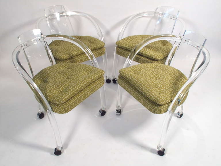 Fantastic set of lucite dining chairs on casters attributed to Charles Hollis Jones. Newley recovered in period fabric.