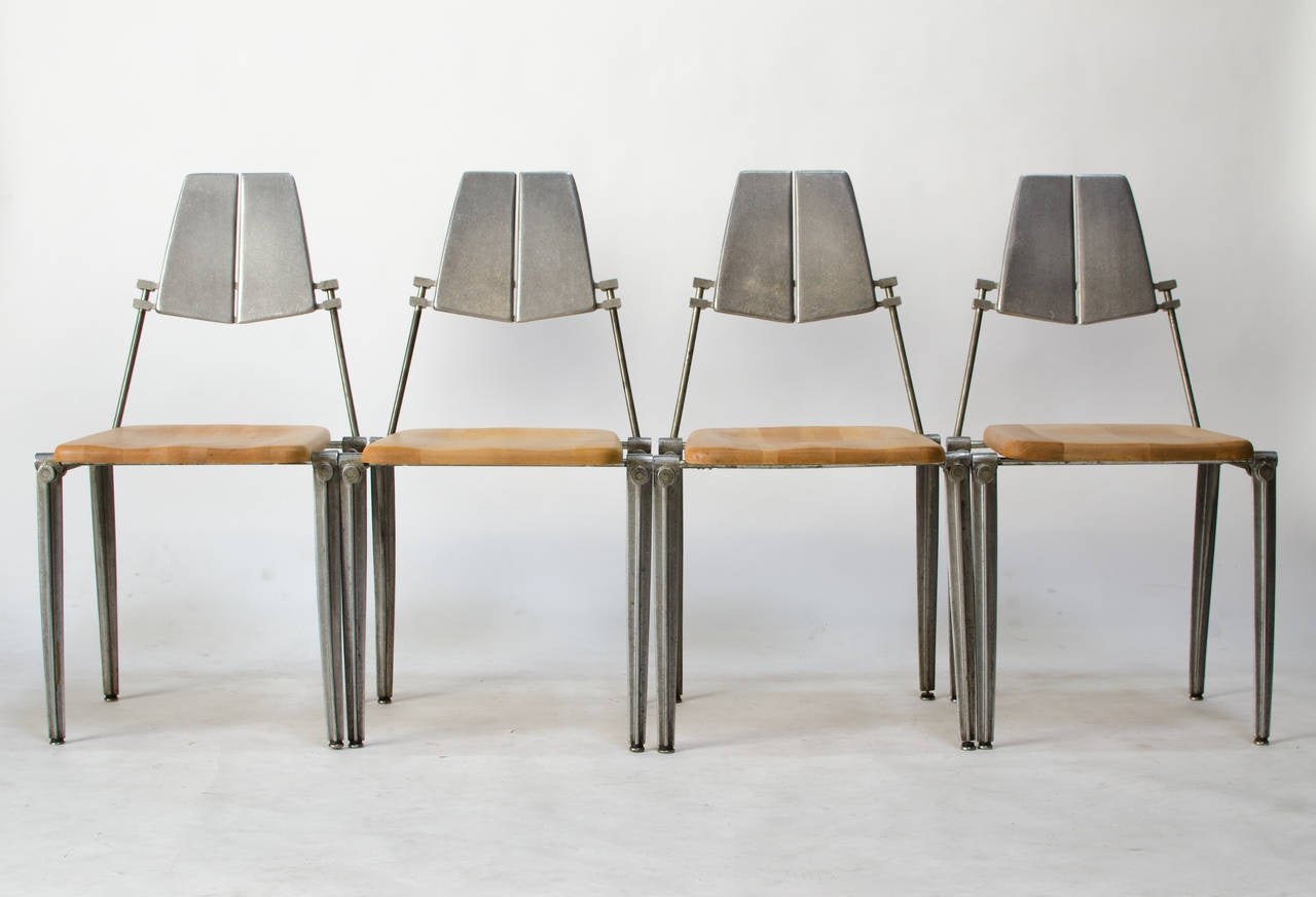 Set of four chairs designed by Robert Josten, circa early 1970s. The chairs have solid maple seats and Josten's unmistakable cast aluminum legs and seat back. Truly a striking California design.