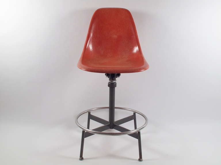 Rare 1st edition drafting side chair. Fiberglass shell is in a stunning terra cotta. This model has full swivel, tilt and height can easily be adjusted to the desired height..28.75