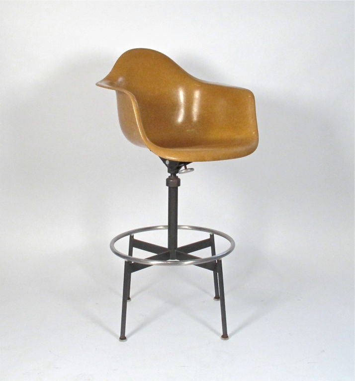 Rare 1st generation drafting base with adjustable tilt and swivel on a dark umber colored fiberglass arm shell.