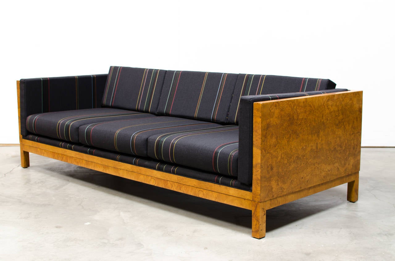 rare Milo Baughman sofa c.1960 executed in an exotic olive burl veneer. The rarest form of this sofa, the wood has been expertly refinished, and upholstered in Paul Smith for Maharam fabric. Wonderfully appreciated in any smart decor, this case sofa
