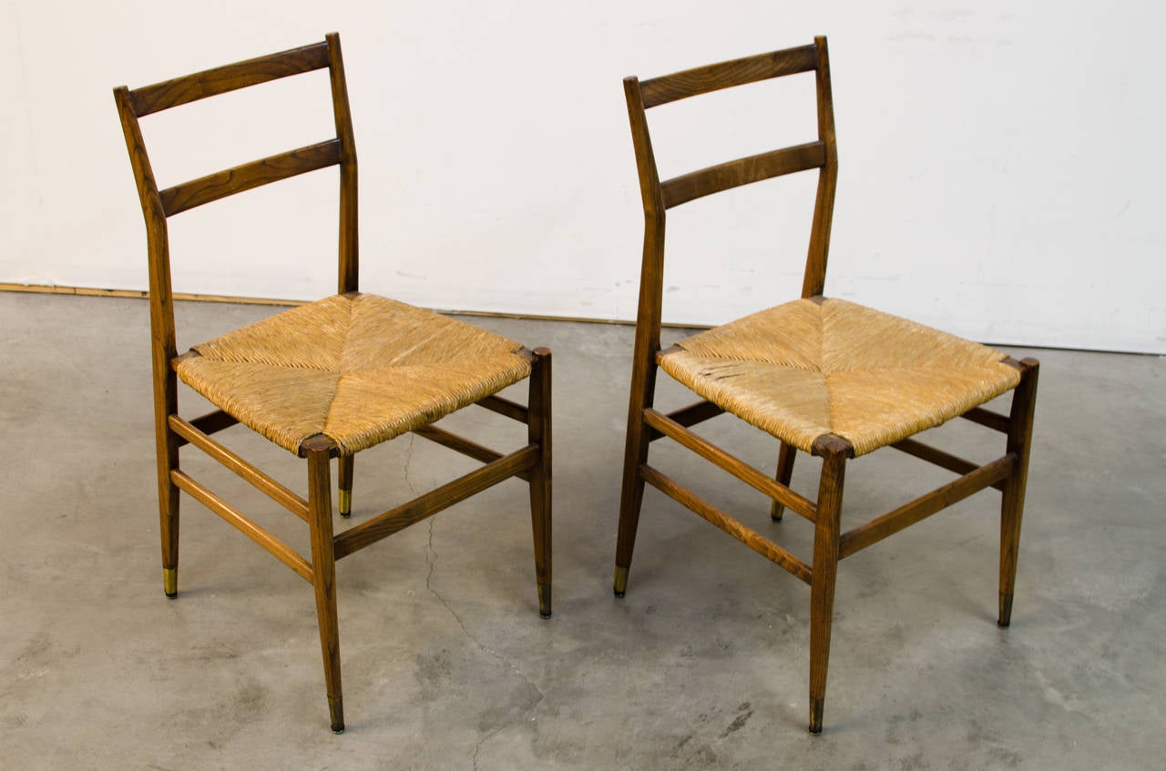 Very early pair of Gio Ponti Superleggera chairs, circa 1951 executed in stained ash. These chairs are in very good original condition. Having been in the collection of the Denver Museum of Contemporary and Modern Art, these chairs are completely