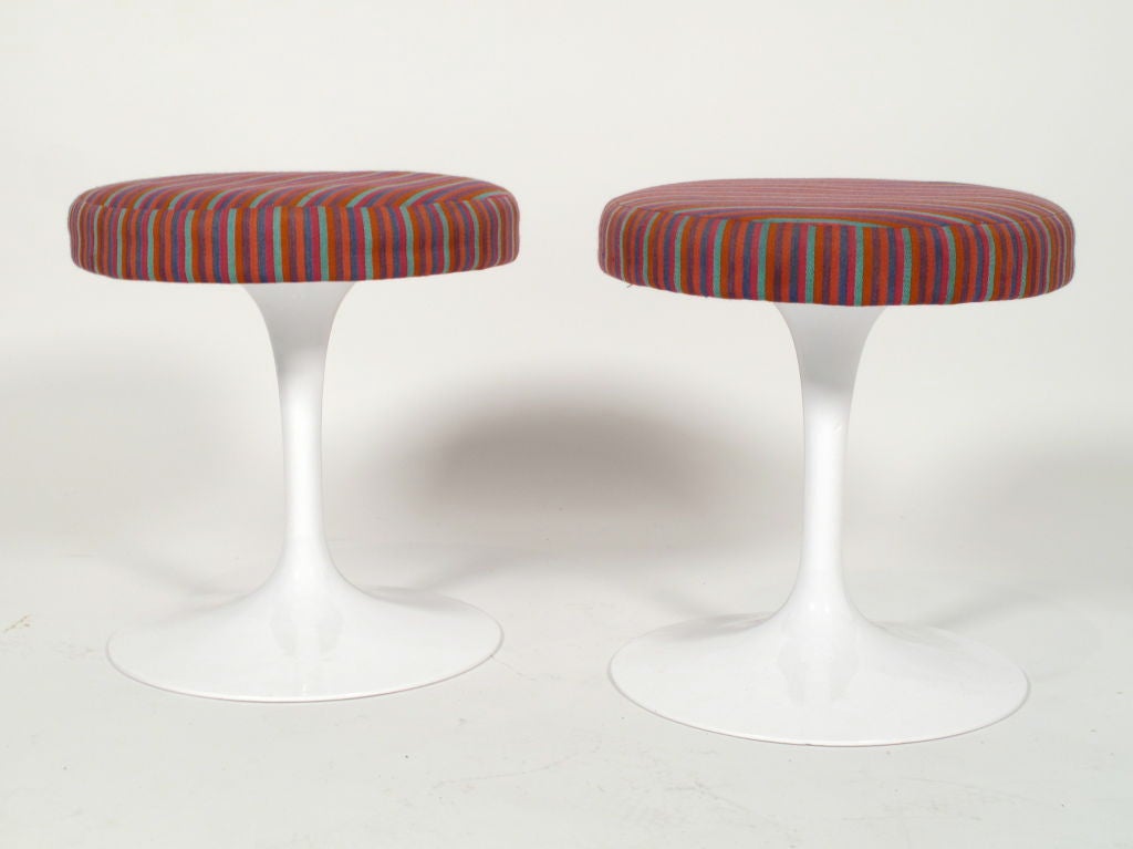 Beautiful pair of iconic vintage Saarinen tulip stool with original Alexander Girard striped fabric. These stools both rotate and 1 retains the original Knoll label.