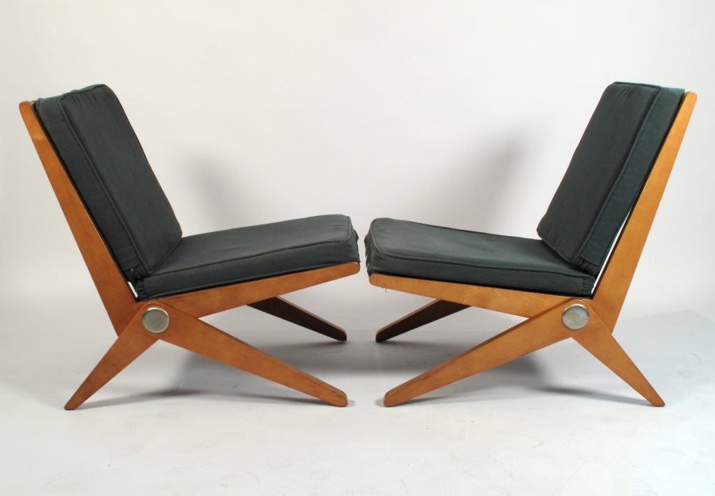 Exceedingly rare pair of lounge chairs designed by Pierre Jeanneret for H.G. Knoll circa 1947. These are in exceptional condition, all original from top to bottom. 1 chair still retains the paper label. This is the first upholstered chair for Knoll.