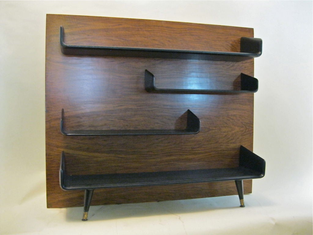 Stand or Floor bookshelf made of oak laquered in black and legs with  brass caps.<br />
This furniture was part of Harold Schwuartz personal collection and comes from his former home located in Palm Beach Florida, As well as the rest of Schwartz