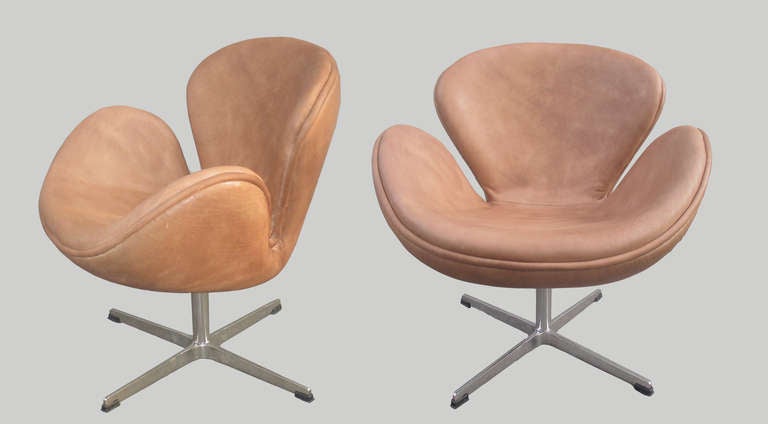 Pair of Arne Jacobsen Swan Lounge Chairs 
Recently upholstered, new leather.