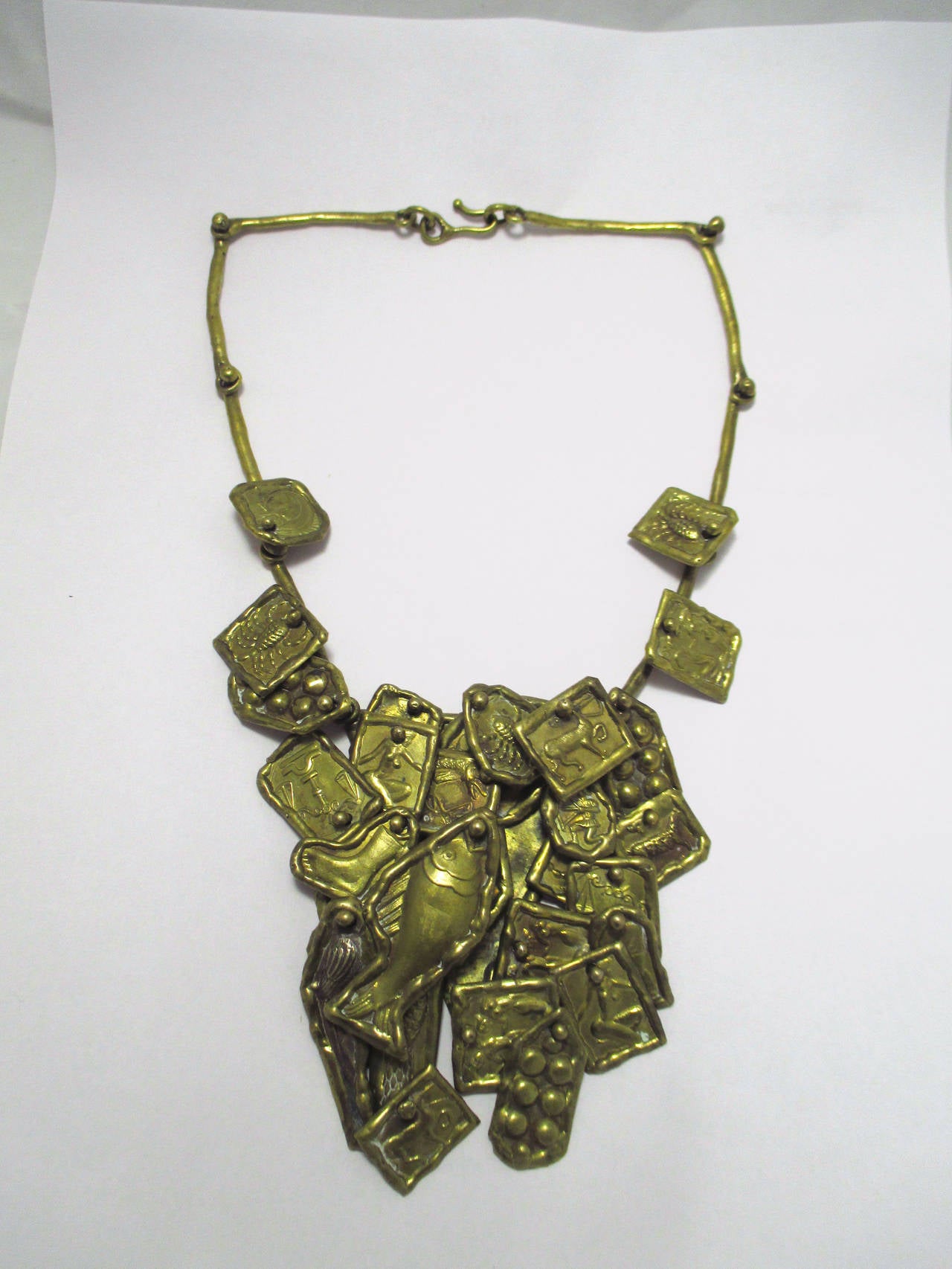A Pal Kepenyes bronze necklace signed on the back. With fish and animal motives.