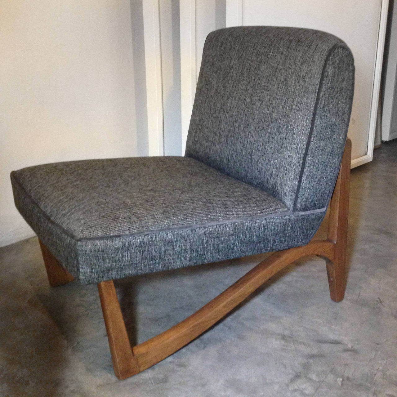 Pair of Midcentury club chairs made on mahogany and gray fabric.