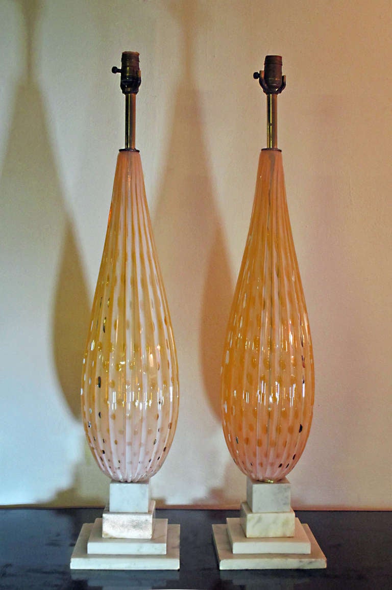 Alfredo Barbini pair of murano glass white opaline in peach with pyramidal marble base. The lamps measure 36 inches from base to the top of the socket, the glass measures 23 inches.
