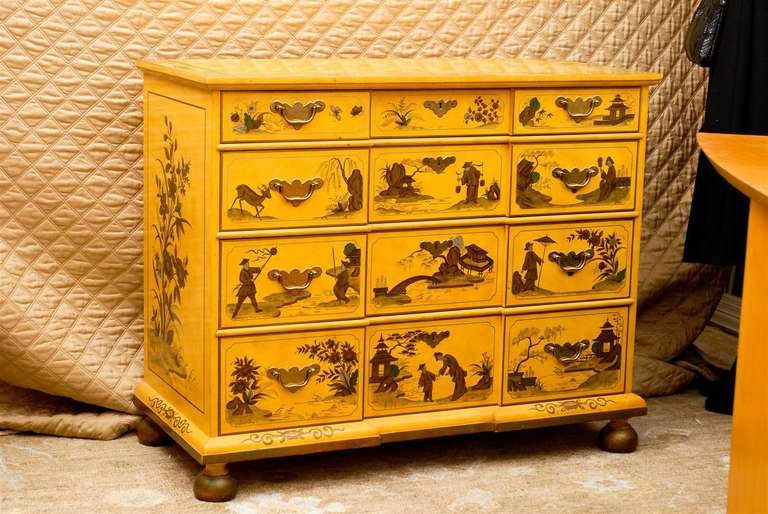 20th Century gold and yellow chinoiserie commode in the Georgian style by Baker Furniture Company with graduated drawers, brass hardware, and resting on bun feet.