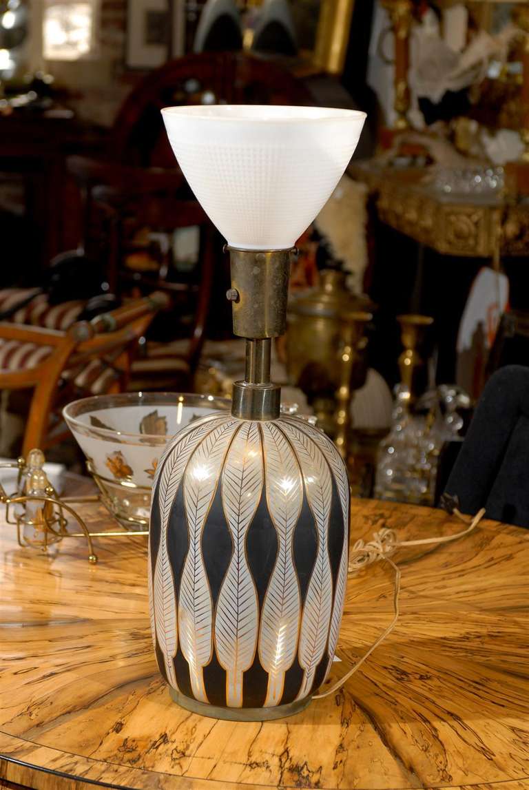 Mid Century Modern porcelain lamp with Art Deco inspired stylized feathers in matte black, gloss white and details in gilt.