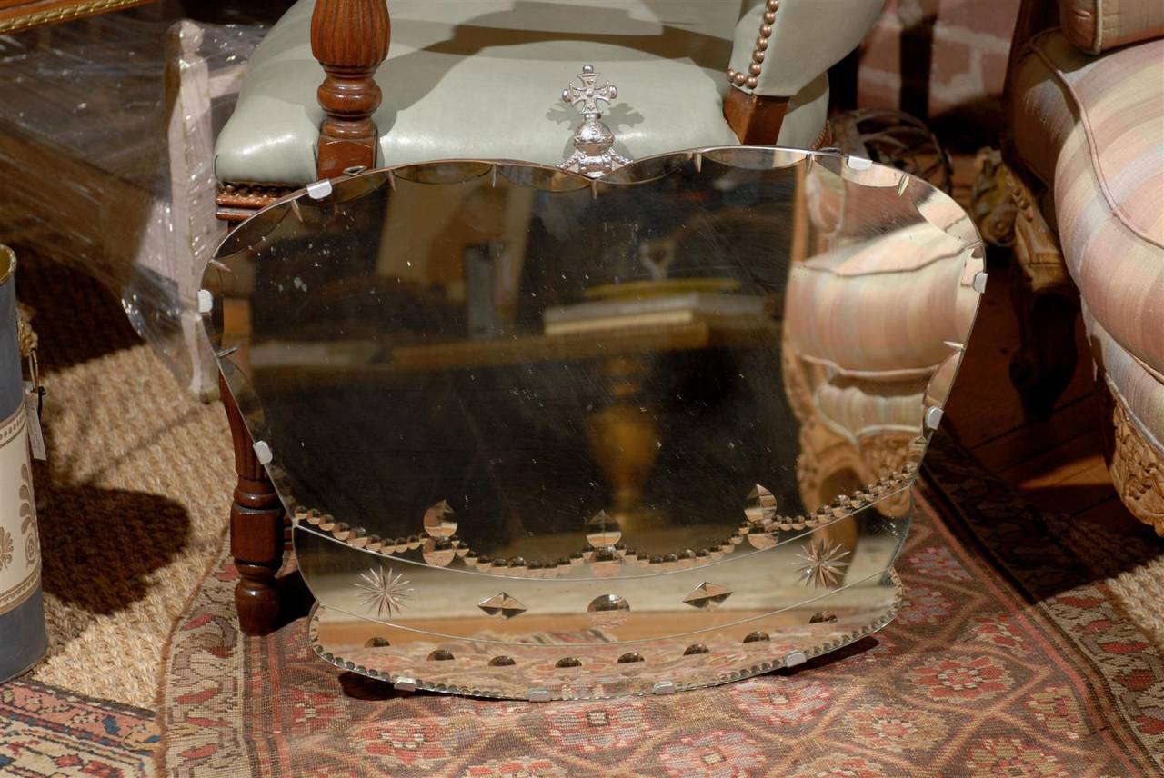 Rare 20th century wall mirror made by W.S. Laurie's Glass Works, Wolverhampton to commemorate George VI and Queen Elizabeth in 1937.  The mirror is of British plate glass and hand workmanship in the shape of a crown with a scalloped beveled edge,