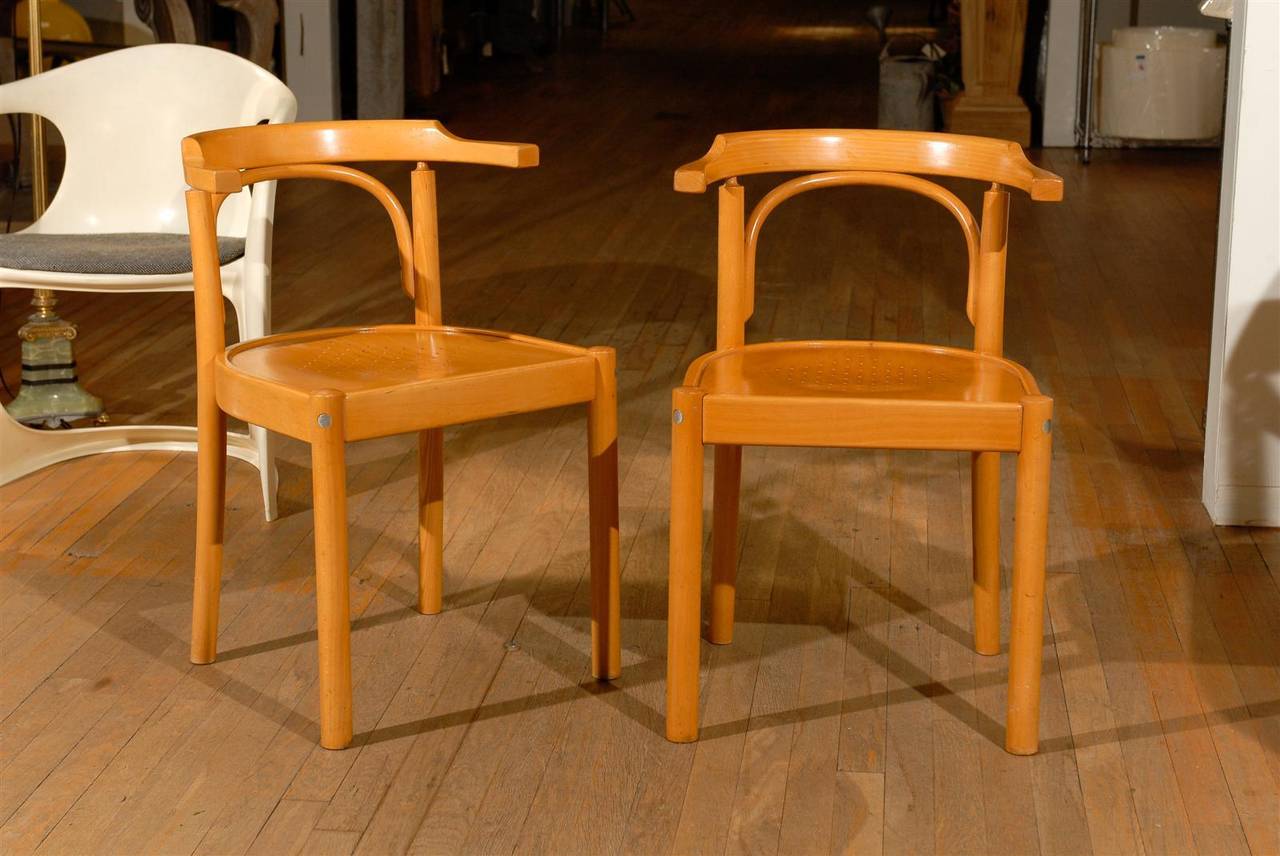 Pair of midcentury beechwood chairs with bentwood details and perforated seats.