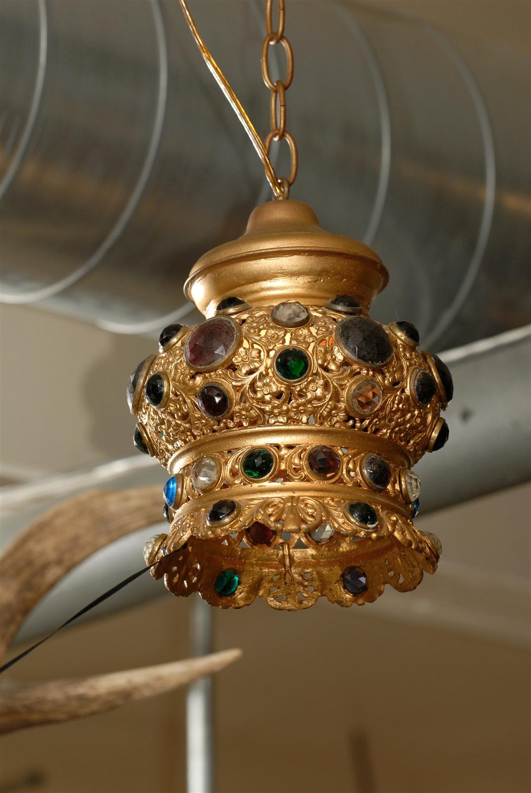 Italian gilt metal lantern with floral pierced decorations and in the shape of a crown, inset with circular, faceted gemstones.