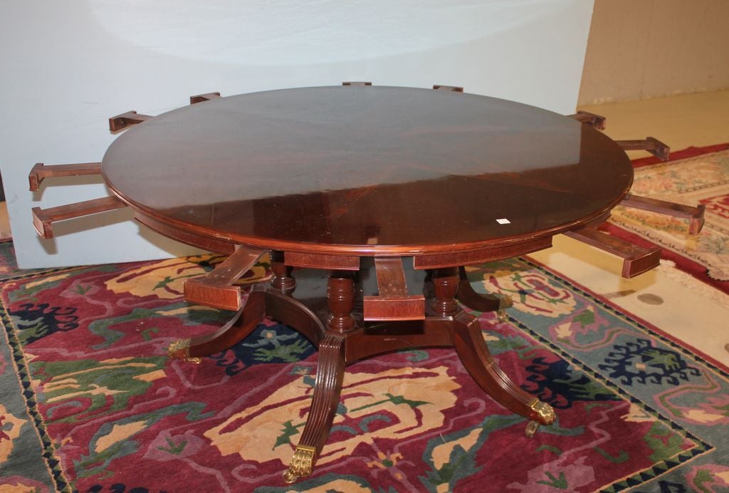 Circular Italian dining table of flame mahogany with dramatic star inlay in the center and cross banding on the 60