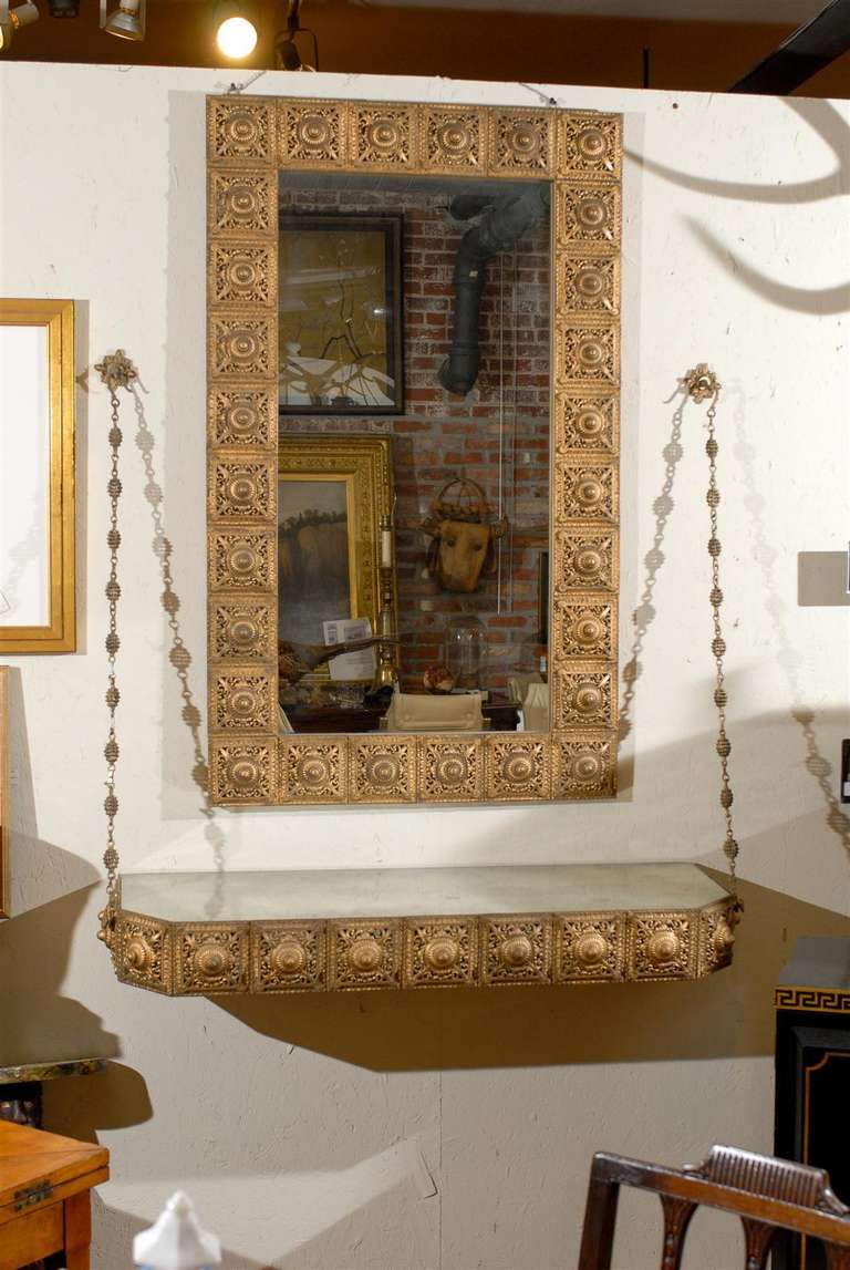 Midcentury Hollywood Regency mirror and wall console made of pierced gilded metal tiles. Console measures: 5